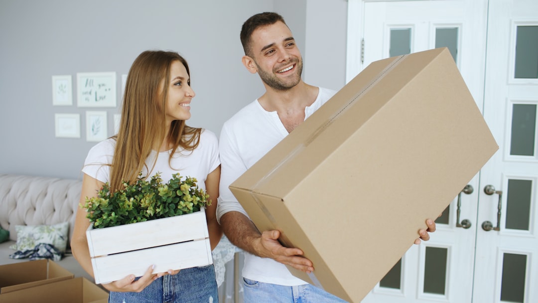 Young happy couple talking while standing at their new home